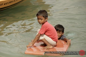 Anak laut swimming and playing in the sea, right outside their homes